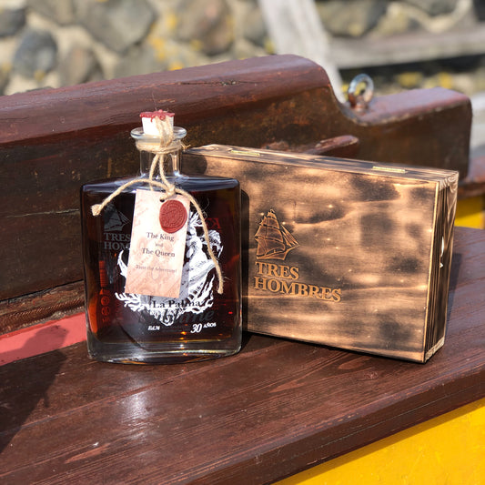 A bottle of the new Tres Hombres Captain's Choice Rum "The King" with its wooden box. A 30 year-old rum from La Palma, distillery Aldea, transported by engineless sailing vessel Tres Hombres.