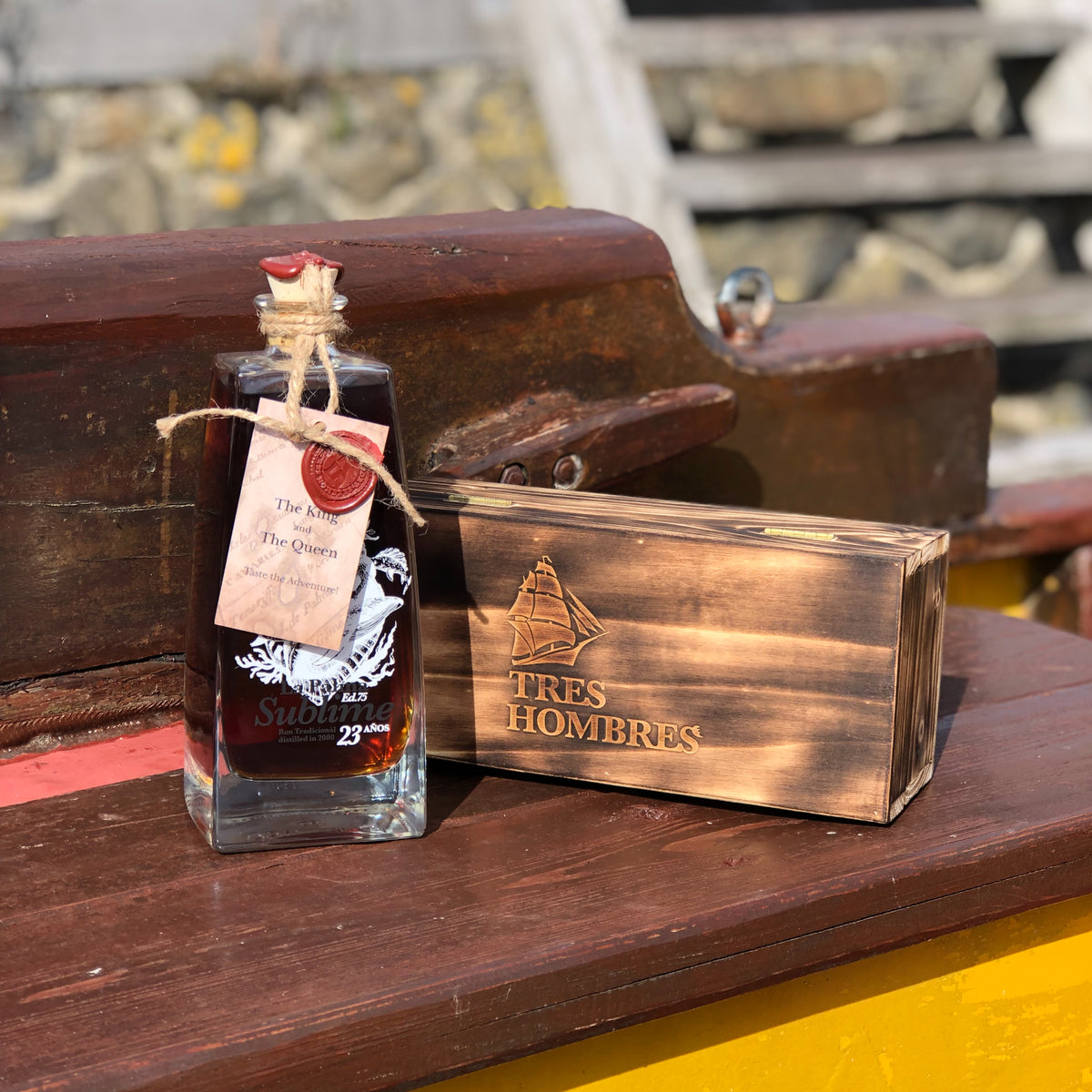 A bottle of the new Tres Hombres Captain's Choice Rum "The Queen" with its wooden box. A 23 year-old rum from La Palma, distillery Aldea, transported by engineless sailing vessel Tres Hombres.